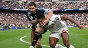 Lionel Messi contests the ball with Jude Bellingham during World Cup semifinal between Argentina and England.