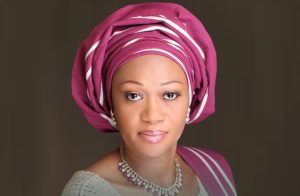Studio portrait of Nigeria’s First Lady Oluremi Tinubu wearing a magenta gele and traditional attire.