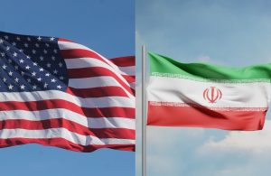 A split-screen image showing a close-up of the waving American flag on the left and the Iranian flag flying on a pole against a blue sky on the right.