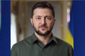 Official portrait of Ukrainian President Volodymyr Zelenskyy in a dark suit against a plain background